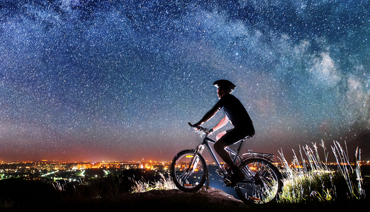 boy on bike looking at stars